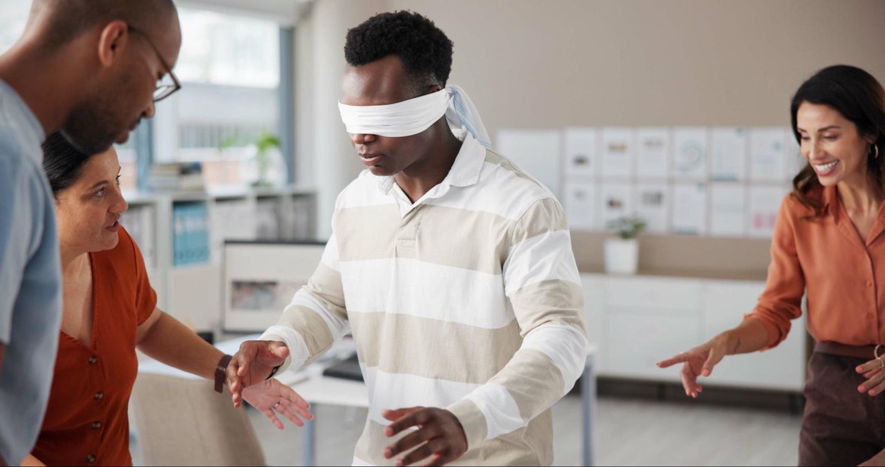 Person walking with a blindfold on representing expertise blindness